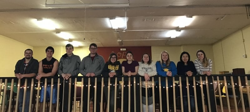 Students standing at a railing.