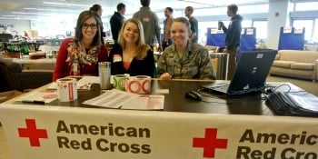 Blood drive volunteers sitting a check-in table