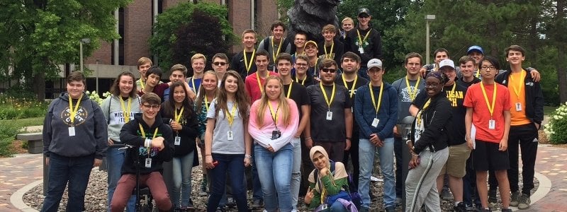 An SYP group photo in front of the Husky statue on Michigan Tech's campus.