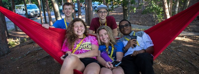 Five SYP students hang out in a hammock.