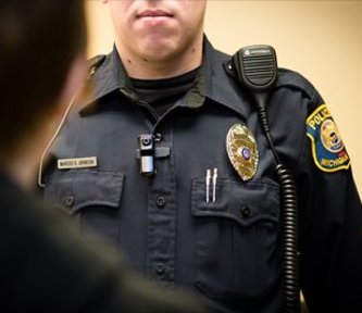 Public Safety wearing video cameras Public Safety officer wearing a lapel camera.
