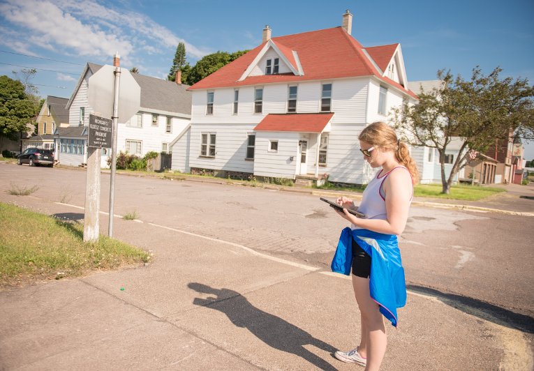 In this picture, a student participating in the GRACE project uses a GPS-enabled iPad to plots points around the communities of Calumet and Laurium.