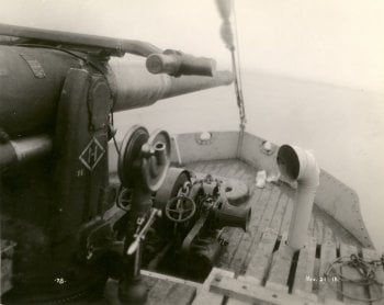 The deck of a boat with a mounted gun and lake superior in the background, black and white circa 1918 from City of Thunder Bay archives