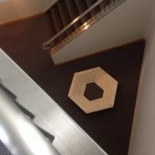 A wooden hexagon constructed by a student near the stairwell at the Rozsa Center for the Performing Arts. The hexagon starts smaller at the base and increases in size at the top.