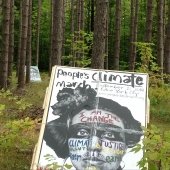 Two People’s Climate March posters, attached to wooden display stands, along the Tech Trails.
