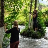 Lisa Gordillo and student Hannah Fisher work on an art installation in the San Juan River. Aguacatán, Guatemala.