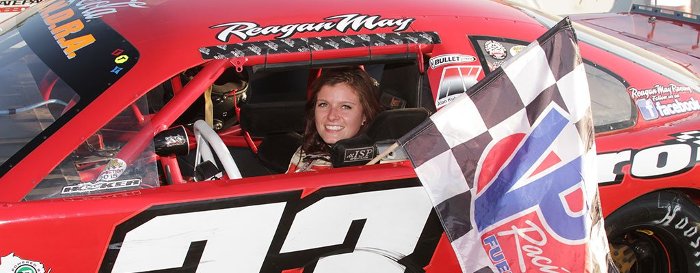 Reagan May in her #33 car with the checkered flag..