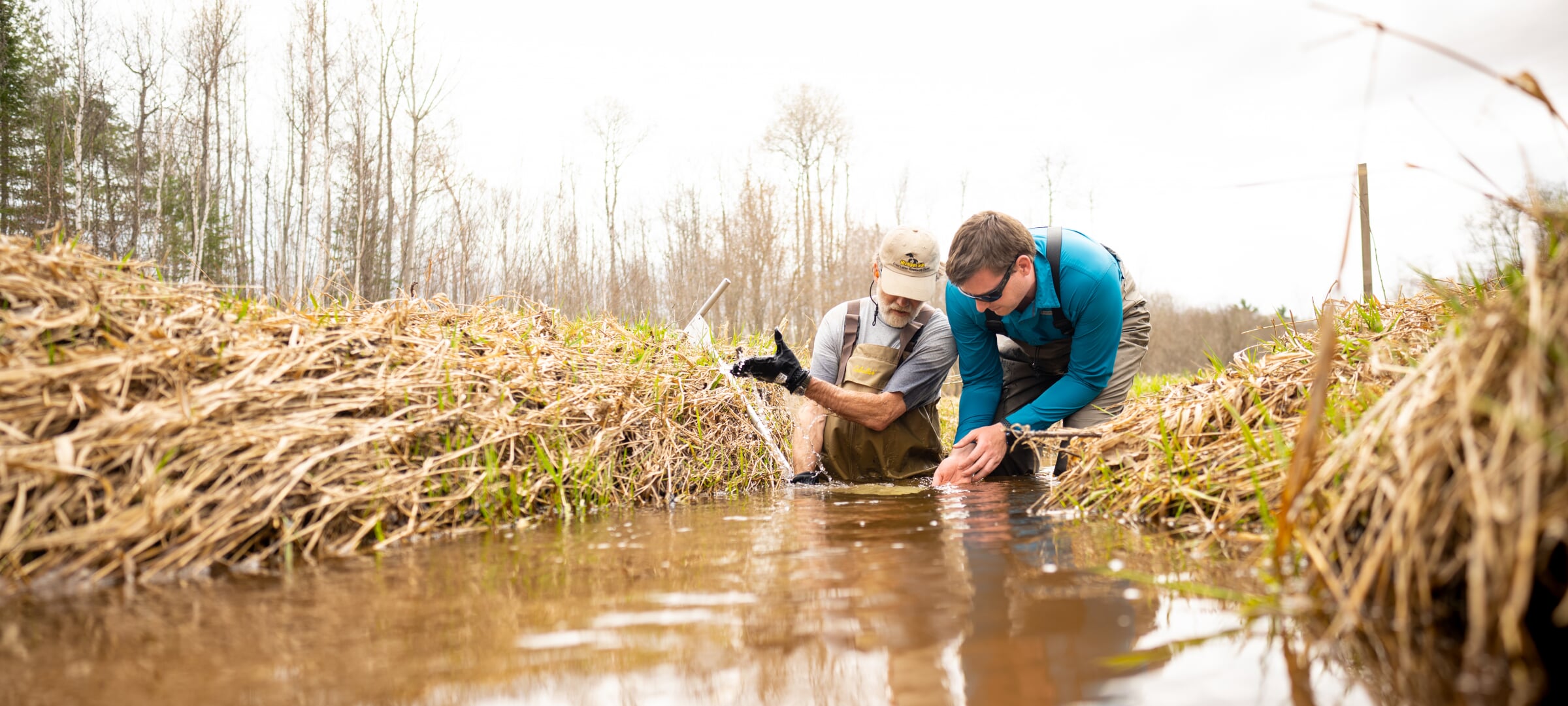 Two people doing research in a stream.
