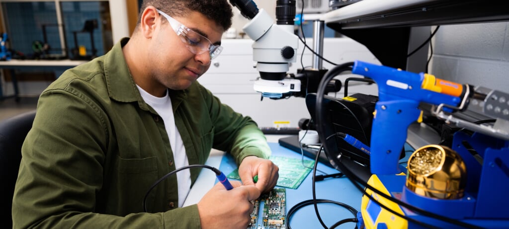 Student working on an electrical component in the Plexus Innovation Lab