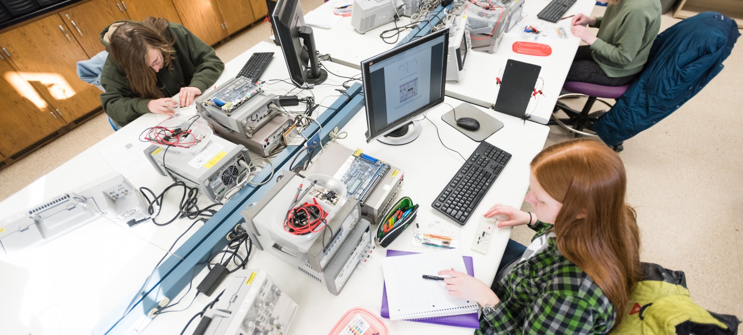 Computer engineering students working with computers.