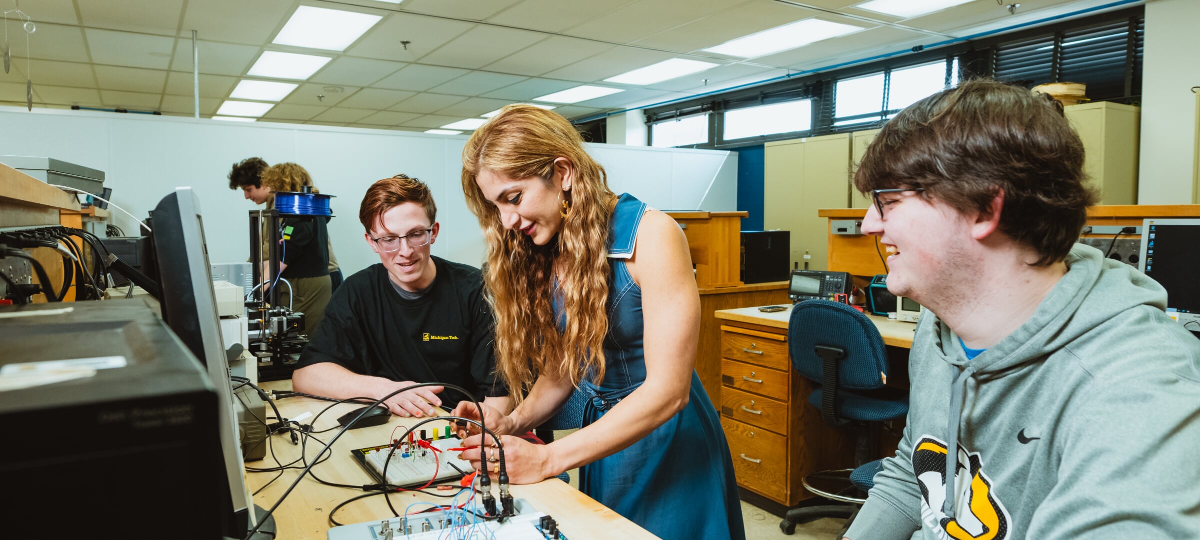 Students working in a group together with wiring and a computer