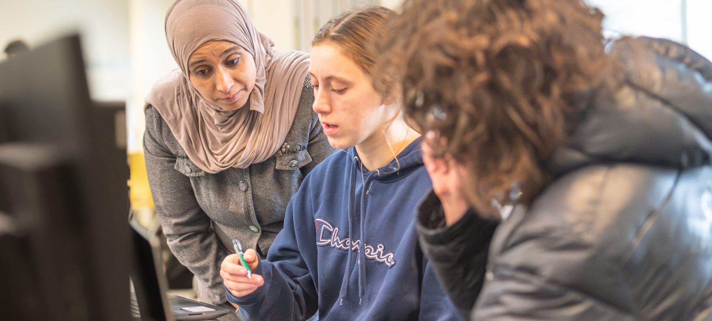 Students discussing data with professor.
