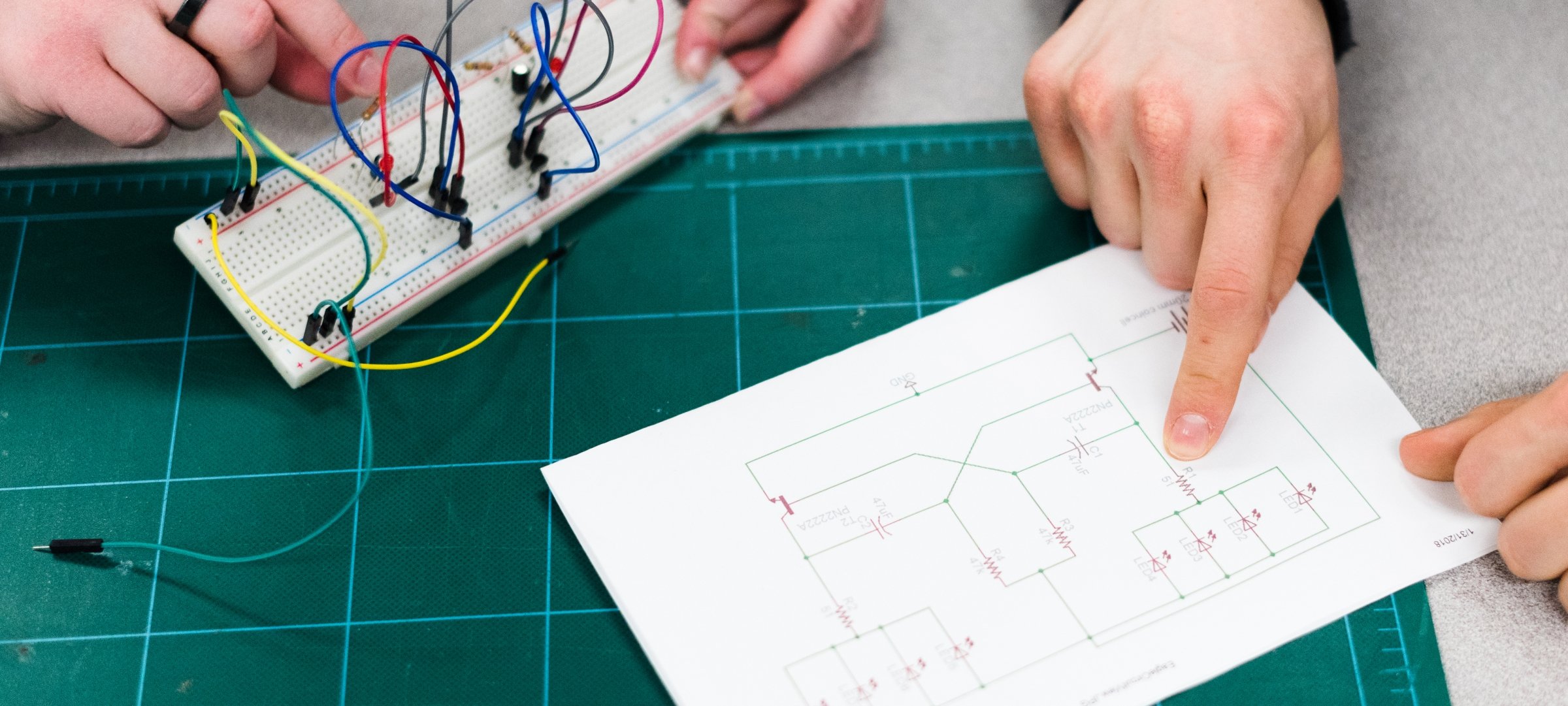 Electrical engineering student reading schematics.