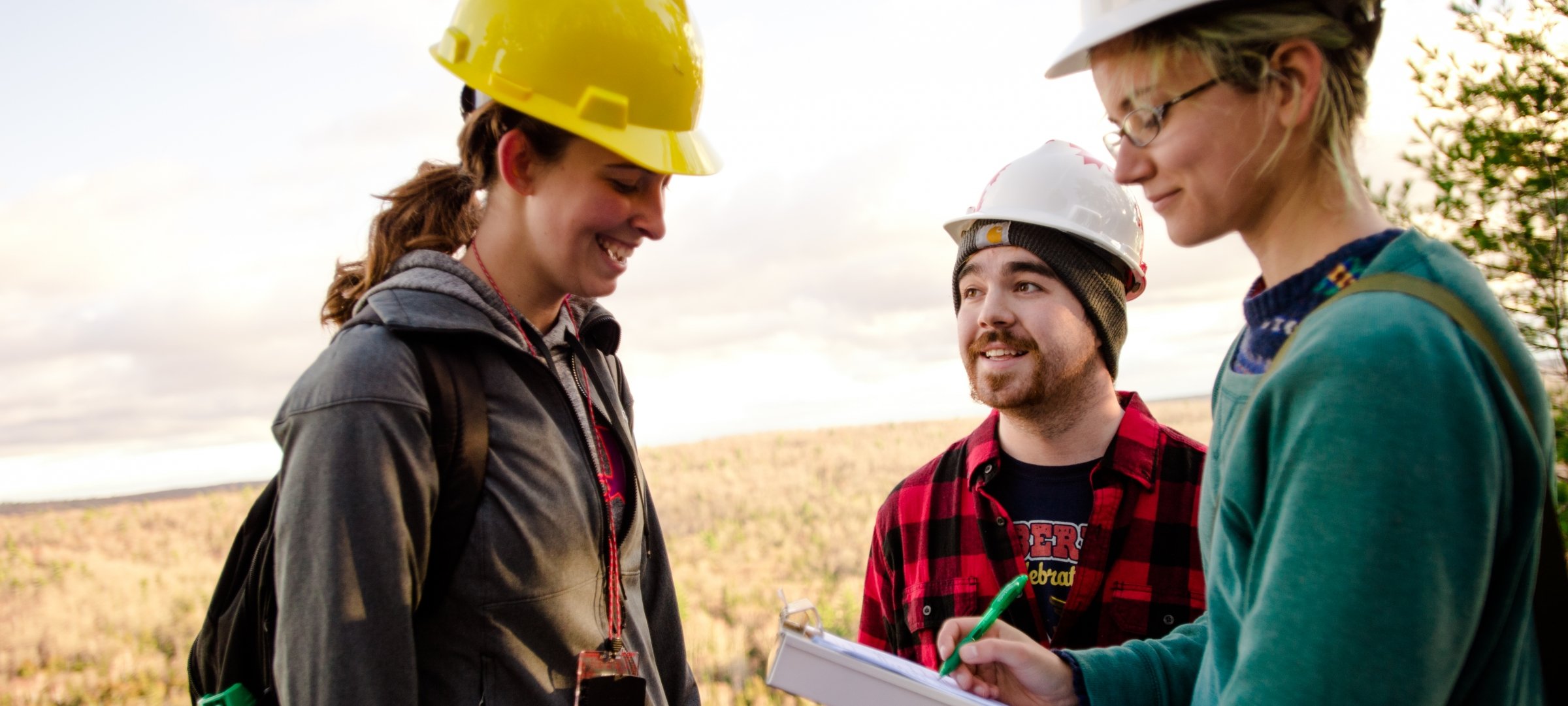 Environmental engineering student working in a field.