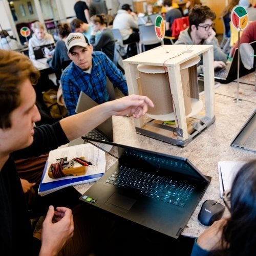 Students in Engineering 101 looking at a project