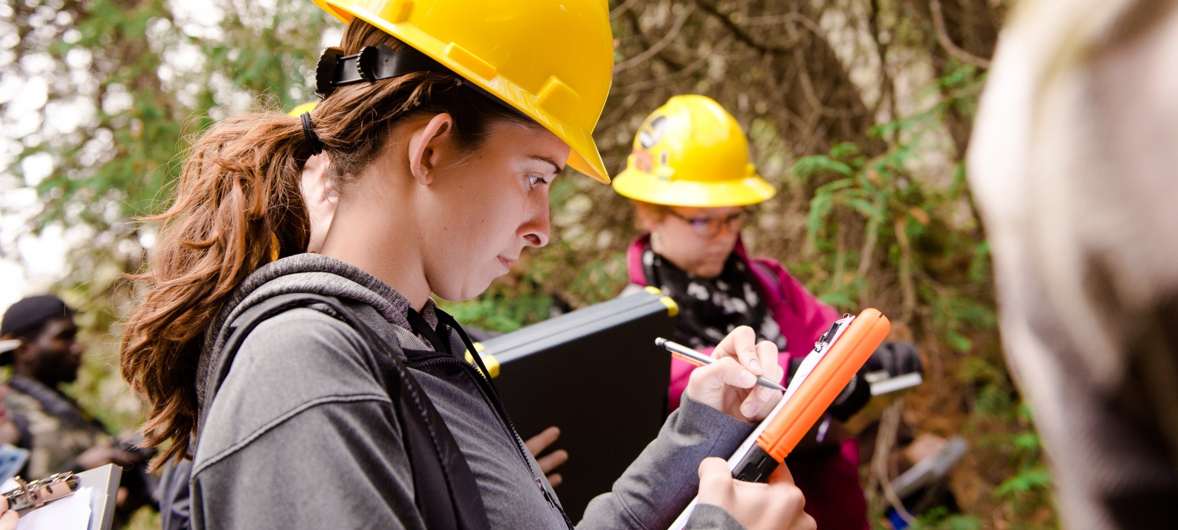 Surveying student working with surveying equipment.