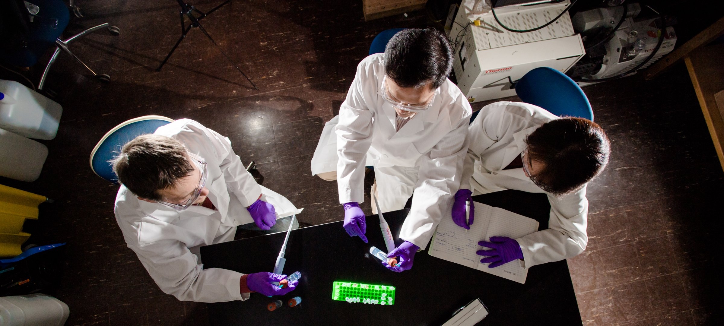 Medicinal chemistry students working on an experiment in a lab.