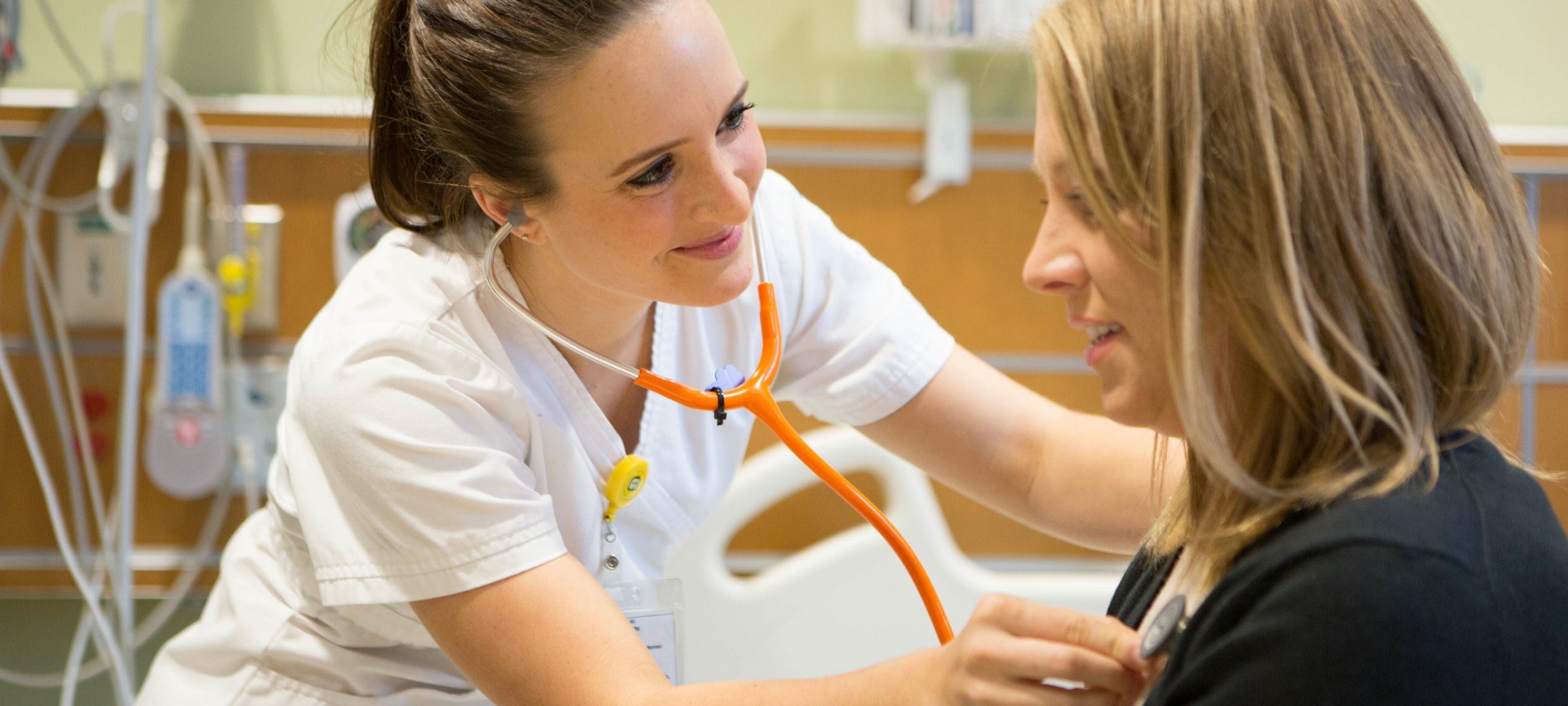 Nursing student listening to the heartbeat of a patient