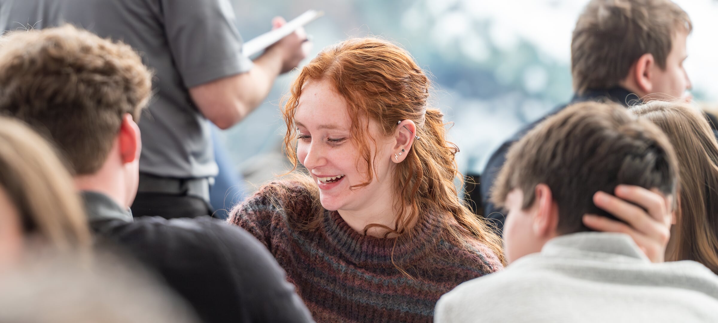 Student smiling with a group of peers