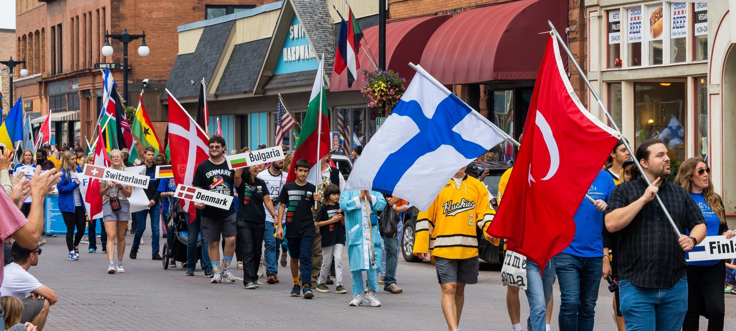 Parade of Nations walking through Houghton beginning the celebration of the countries represented in our community.