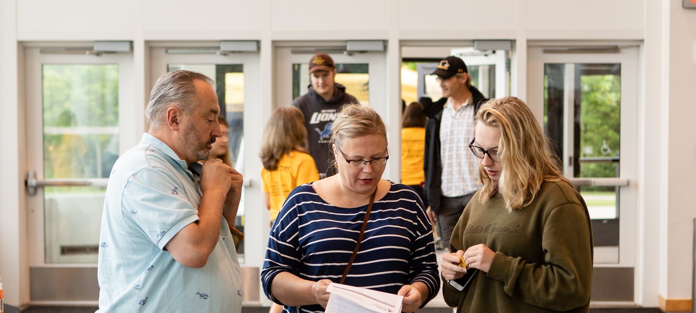 Parents going over the list on move in day