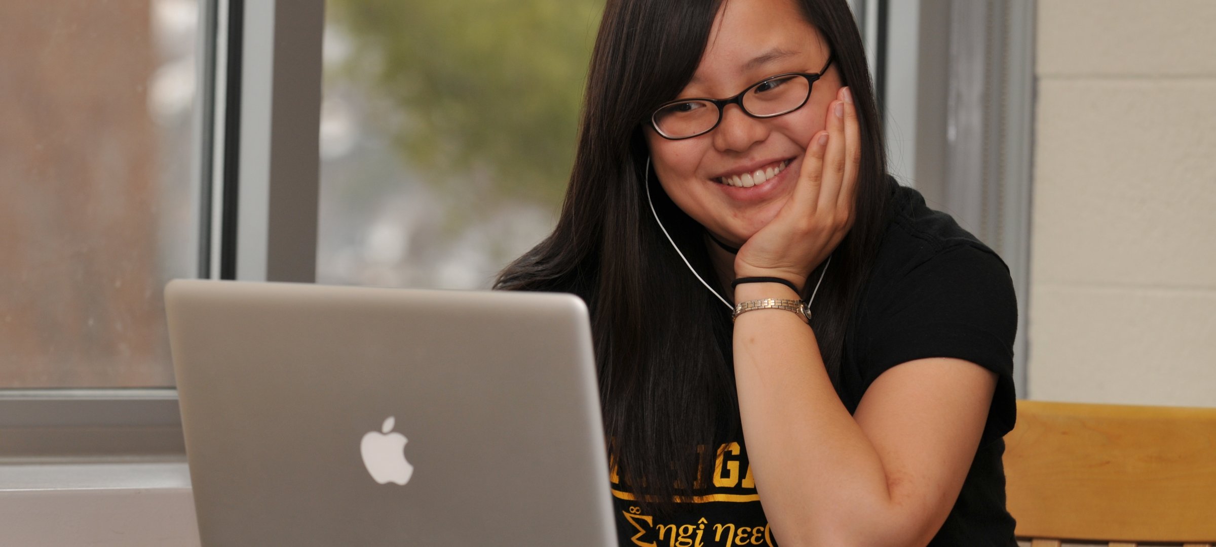 Female student working on homework at a laptop.