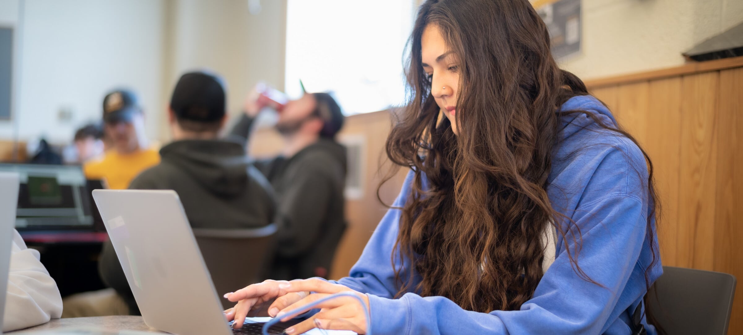 Female student working on homework at a laptop.