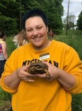 Ayla Zambrano. smiling and holding a painted turtle
