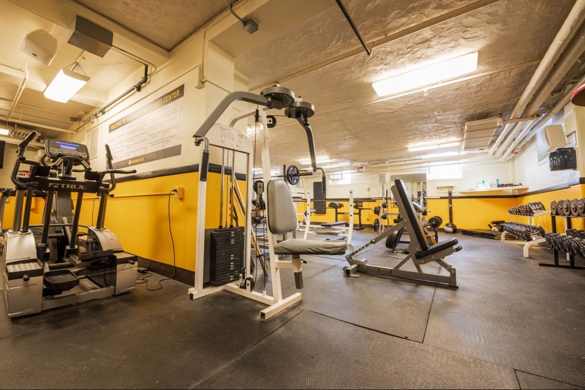 free weights and upper body fitness machine inside the Douglas Houghton Hall fitness center