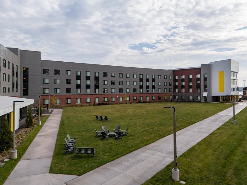 Green with patio chairs in between west and east patios.