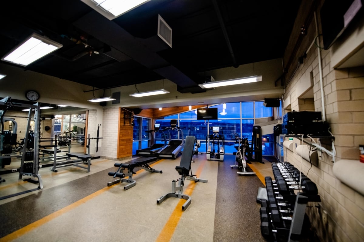 Equipment near the exterior windows in the fitness room.