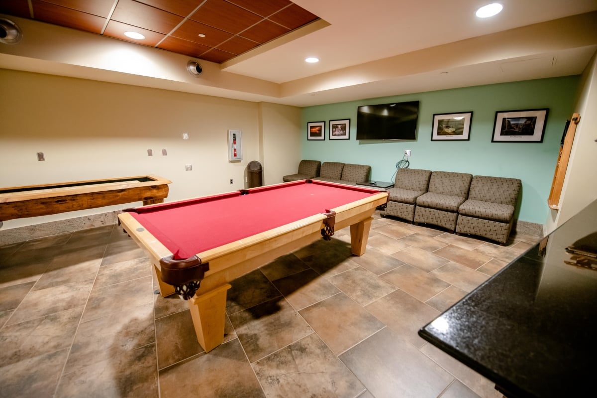 Billiards table and seating area in the game room.