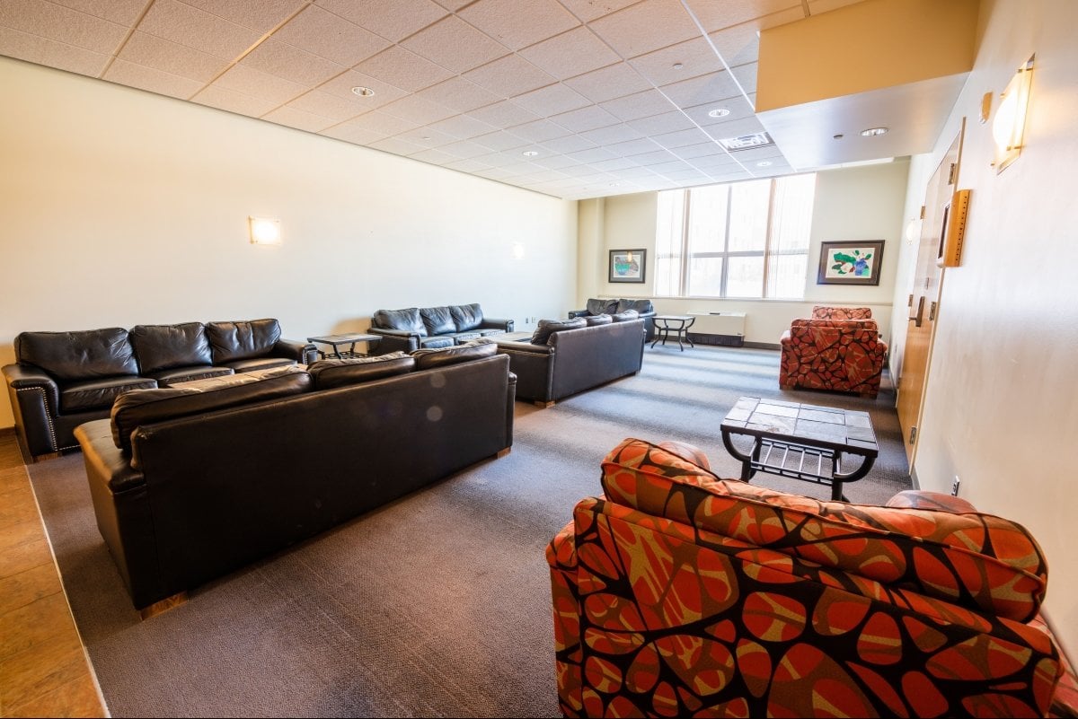 Angled view of lounge near 136W for students with couches, chairs, and tables.