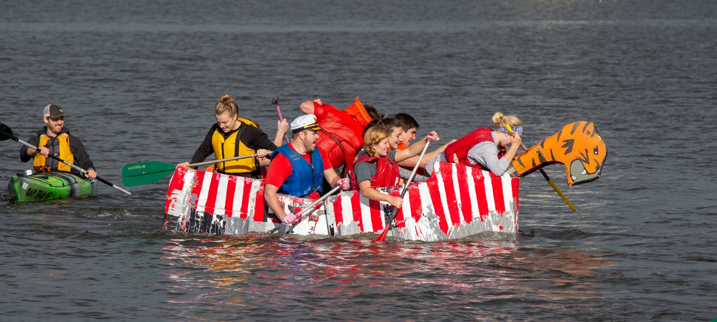 Students paddling a cardboard boat