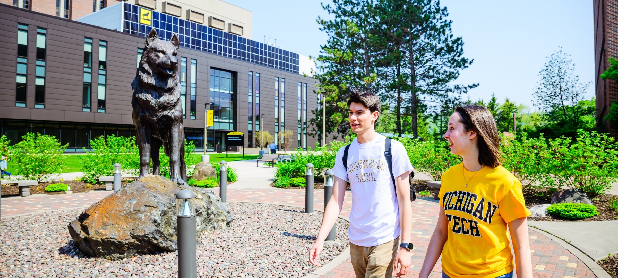 Two students talking and walking on Michigan Tech's campus