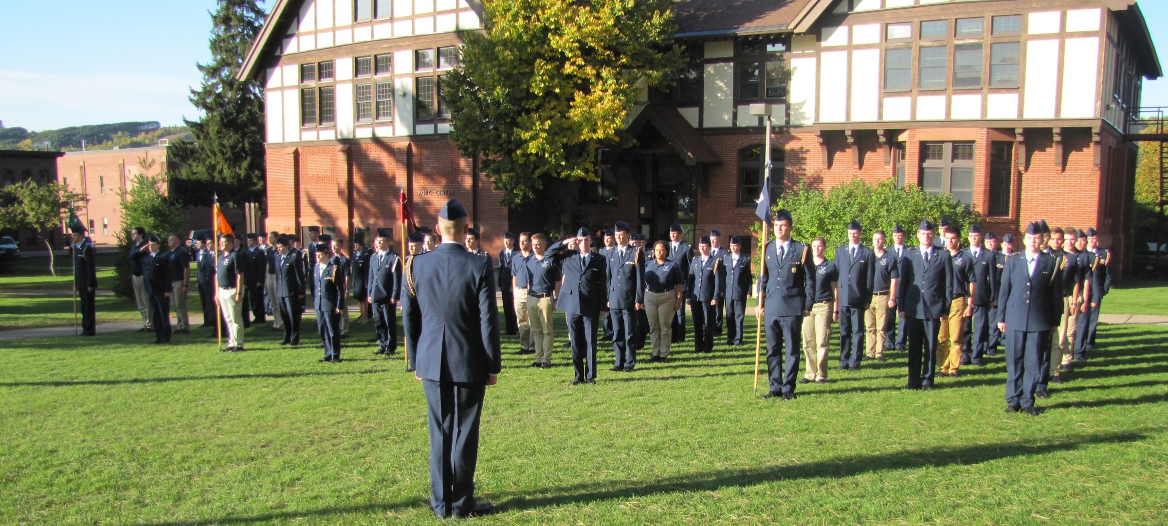 Cadets face student leadership on a sunny day in winter outside the ROTC building in miliary jackets and fatigues