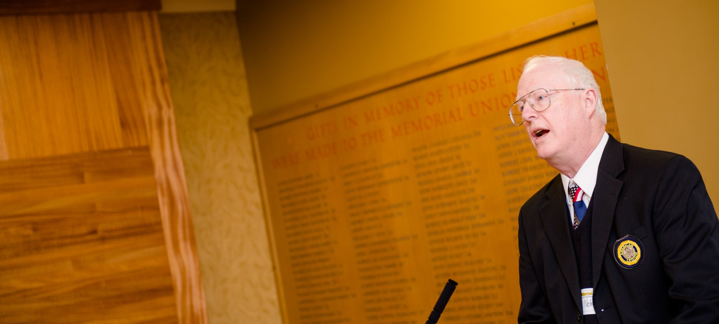 Paul Nelson speaking in front of the War Memorial in the Memorial Union Building