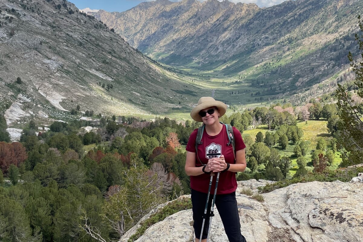 Hedfield in foreground, pictured while on hike in Alaska, with mountain valley in background