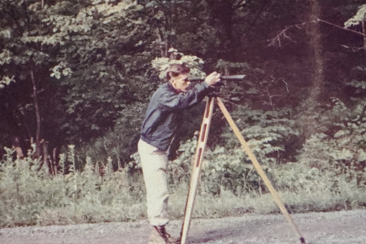 Man surveying on side of road