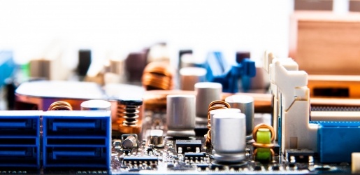 Close up of a board with circuits and power supplies.
