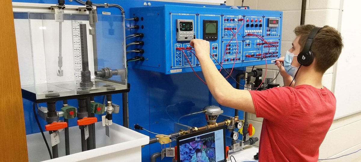 A Mechatronics student operates lab equipment