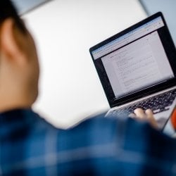 Close up of a student holding up a laptop