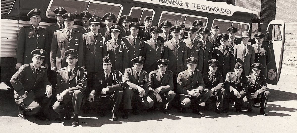 Cadets posing in front of a College of Mining Bus during the 1950-1960s