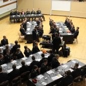Cadets and Command in formal attire at tables in the ROTC gym