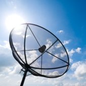 A satellite dish in front of a blue sky