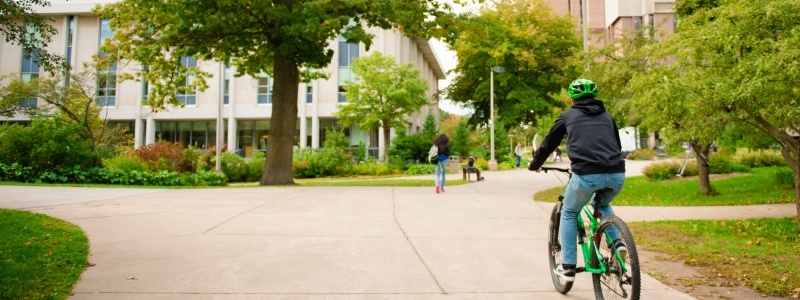 Student biking on Michigan Tech's campus.