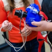 Researchers hold a piece of equipment made to fit over the mouth of a participant