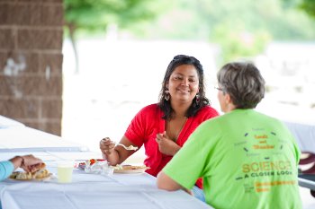 Two people sitting at a table talking.