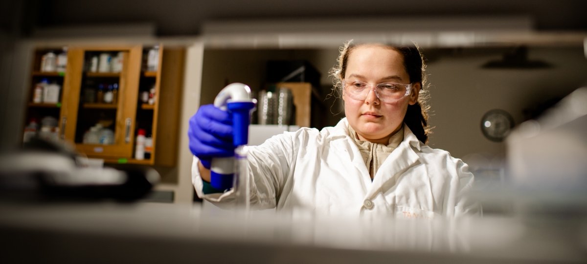 Woman using a tool in a lab