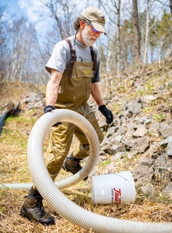 Casey pulling a tube along a river bank